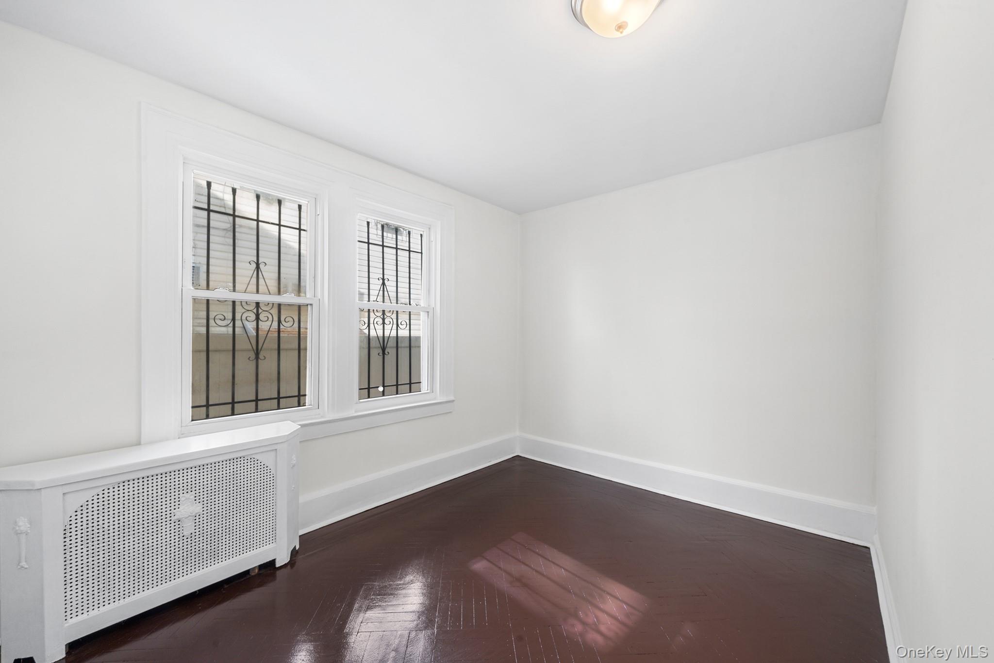 150-44 87th Road Queens, NY 11432 - Photo 12 of 35 an empty room with a window