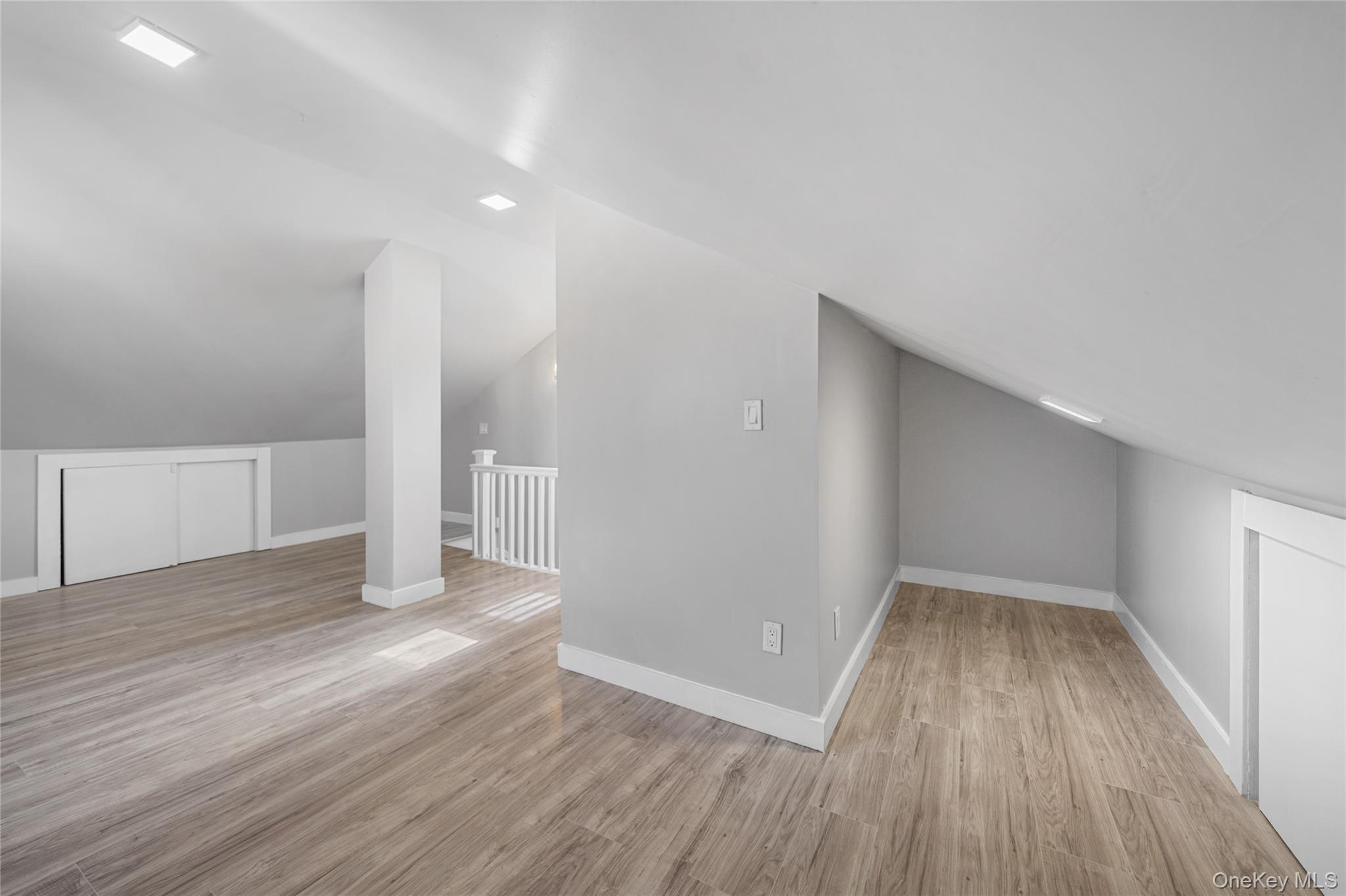 150-44 87th Road Queens, NY 11432 - Photo 25 of 35 a view of an empty room with wooden floor