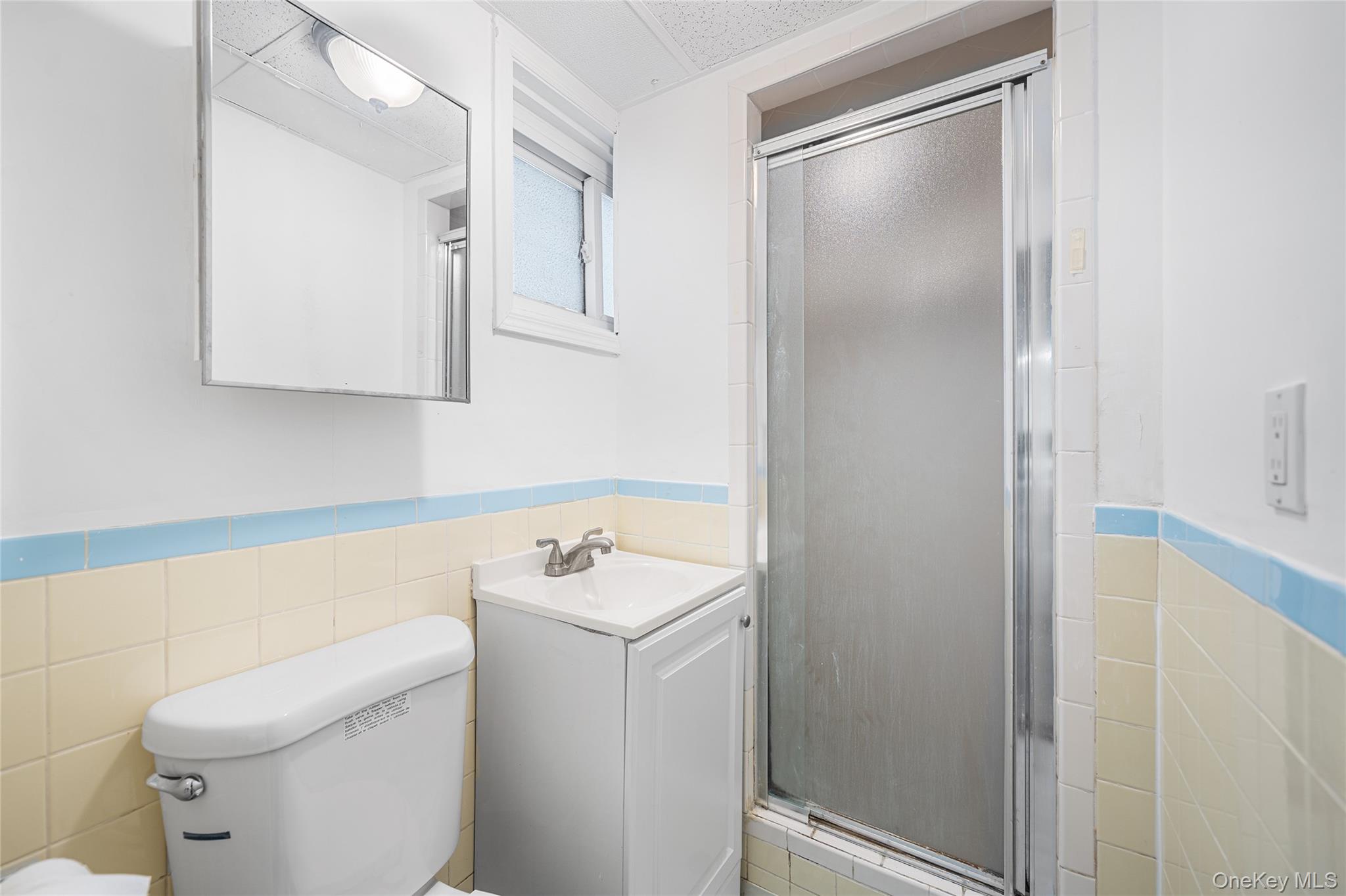 150-44 87th Road Queens, NY 11432 - Photo 30 of 35 a bathroom with a toilet sink and mirror