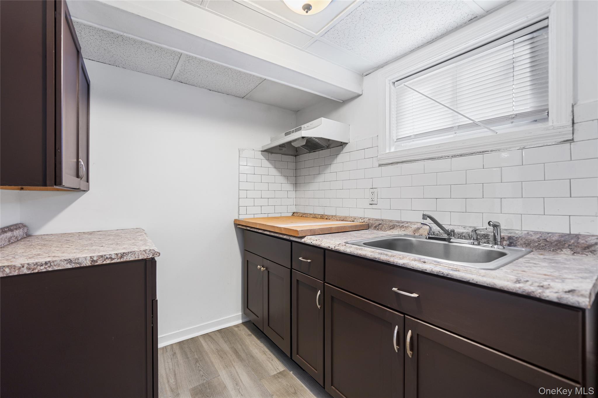 150-44 87th Road Queens, NY 11432 - Photo 31 of 35 a sink and a mirror