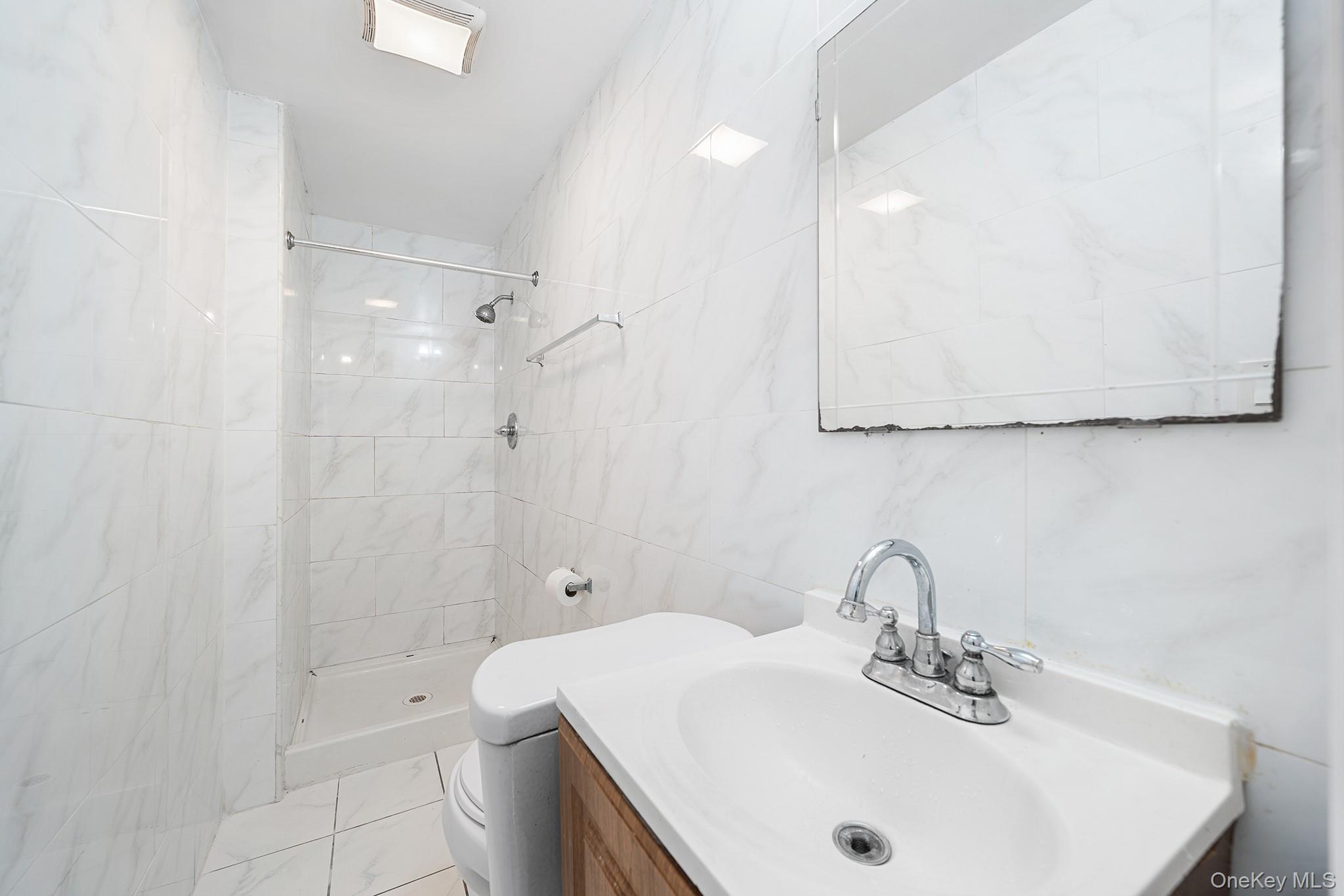 150-44 87th Road Queens, NY 11432 - Photo 5 of 35 a bathroom with a sink a toilet and shower