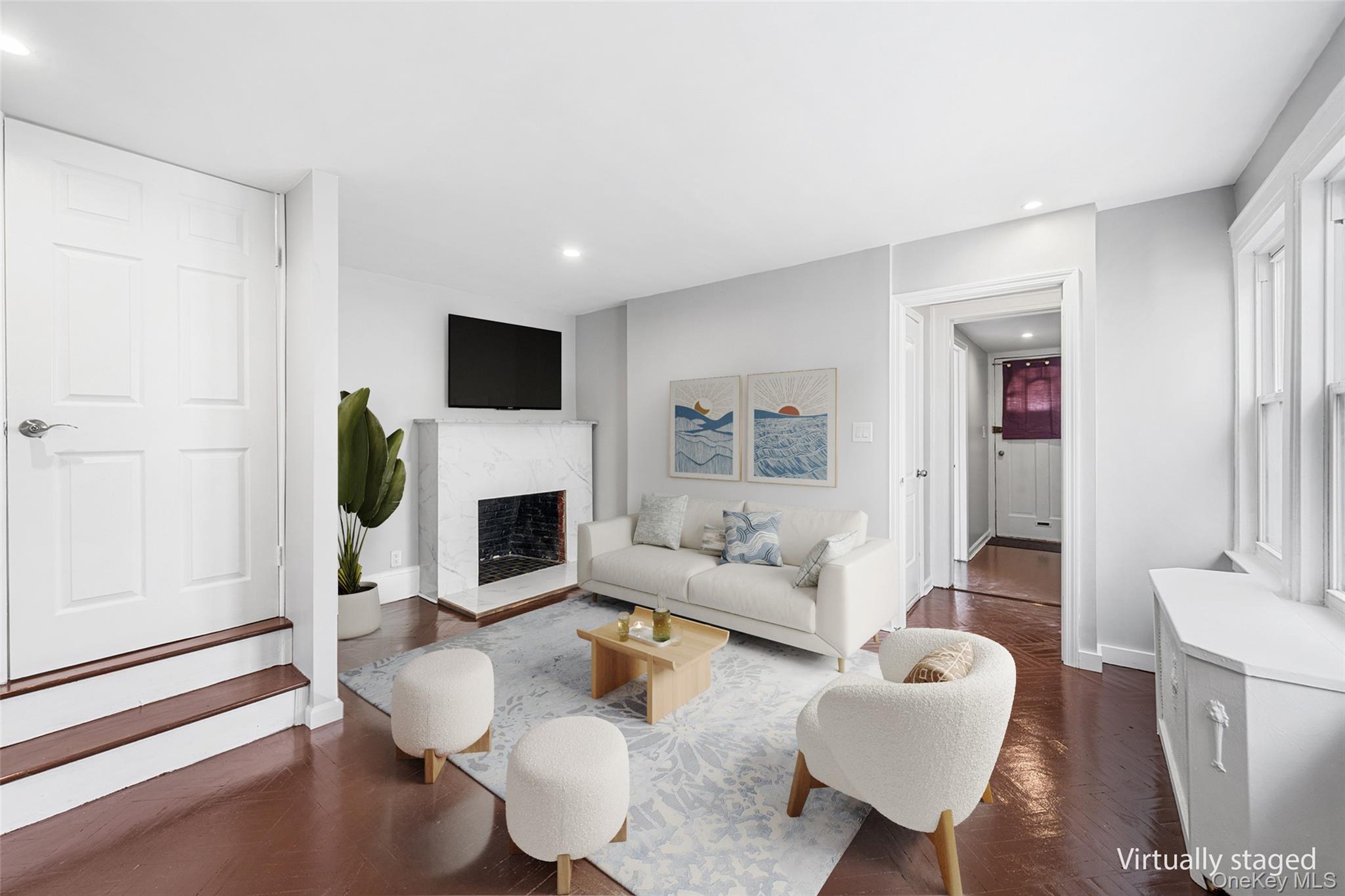 150-44 87th Road Queens, NY 11432 - Photo 9 of 35 a living room with furniture a fireplace and a flat screen tv