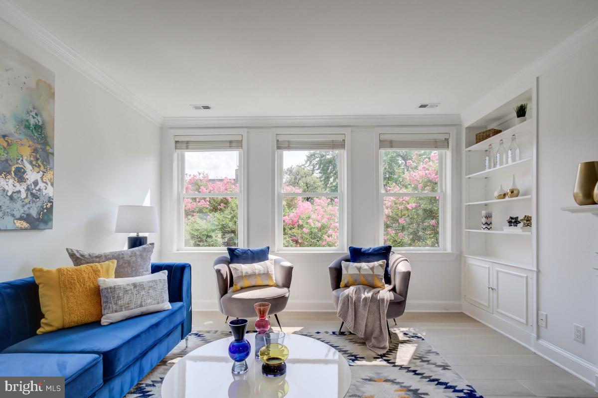 1201 O Street Northwest, Unit 2A Washington, DC 20005 - Photo 10 of 31 a living room with furniture and a large window