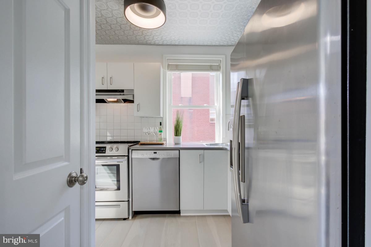 1201 O Street Northwest, Unit 2A Washington, DC 20005 - Photo 16 of 31 a kitchen with white cabinets and white appliances