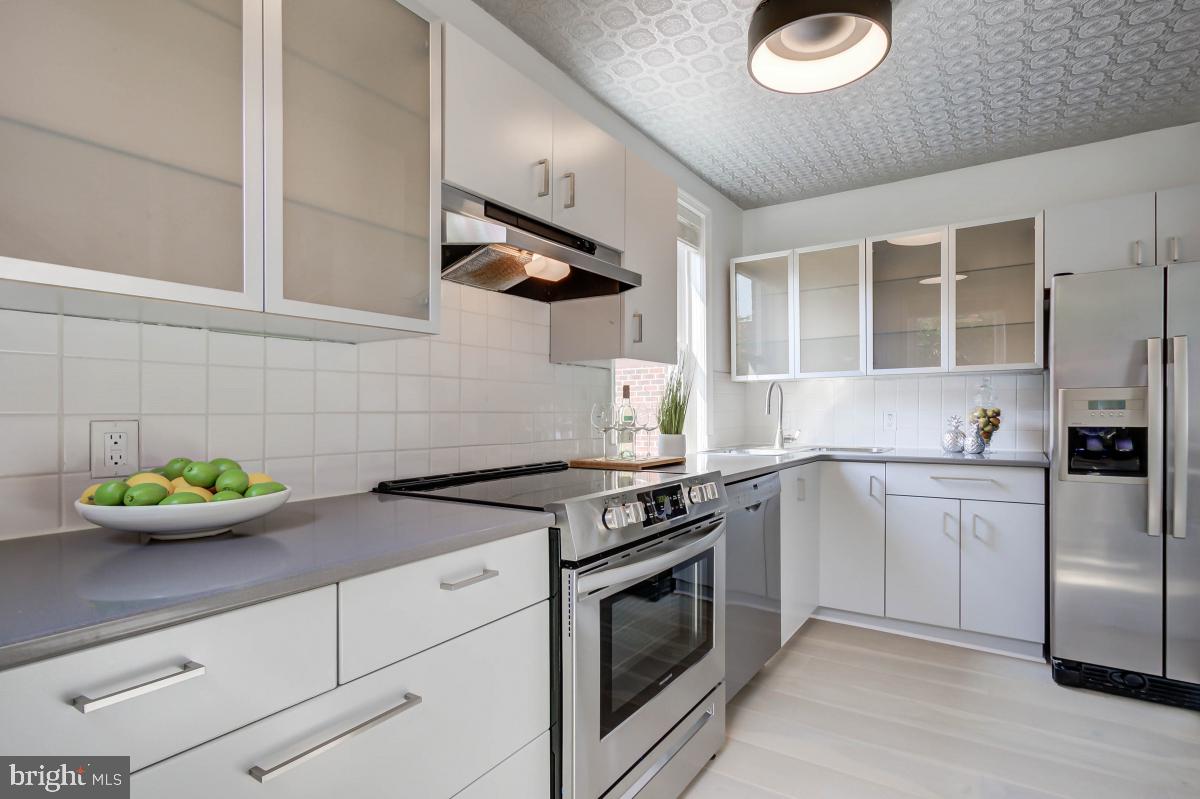 1201 O Street Northwest, Unit 2A Washington, DC 20005 - Photo 19 of 31 a kitchen with stainless steel appliances granite countertop a sink and a stove