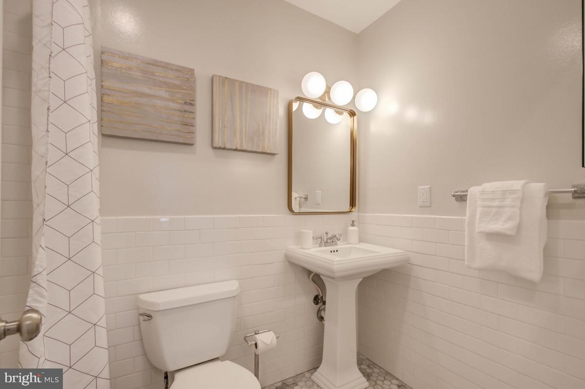 1201 O Street Northwest, Unit 2A Washington, DC 20005 - Photo 20 of 31 a bathroom with a sink mirror toilet and shower