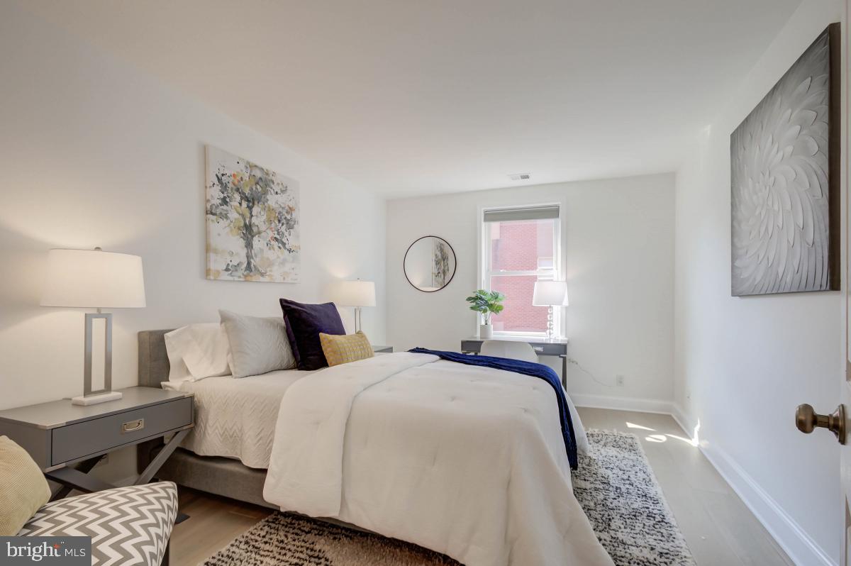 1201 O Street Northwest, Unit 2A Washington, DC 20005 - Photo 27 of 31 a bedroom with a bed and a lamp with the dresser