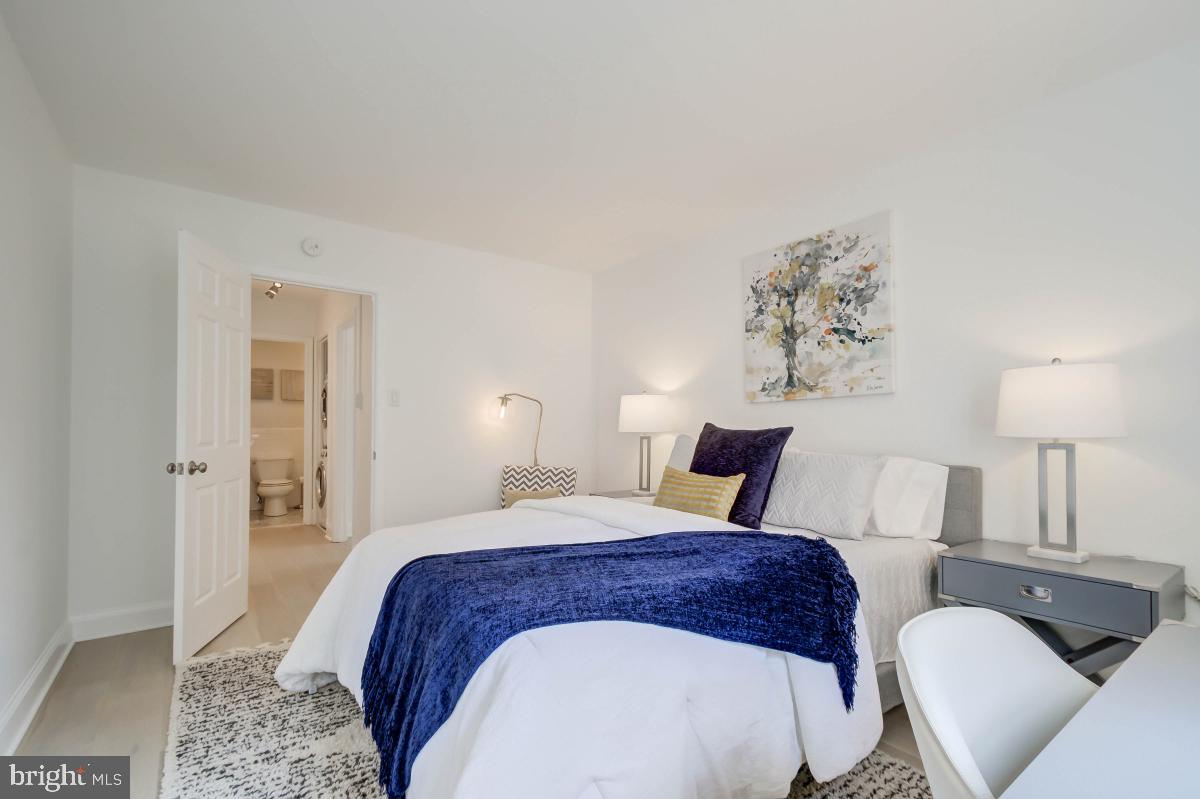 1201 O Street Northwest, Unit 2A Washington, DC 20005 - Photo 28 of 31 a bedroom with a bed a lamp and a couch