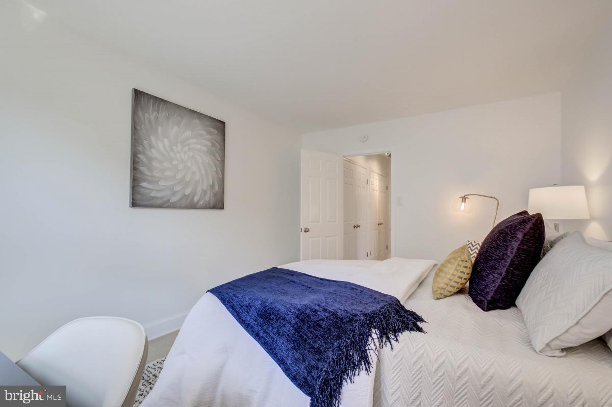 1201 O Street Northwest, Unit 2A Washington, DC 20005 - Photo 29 of 31 a bedroom with a bed and a chair