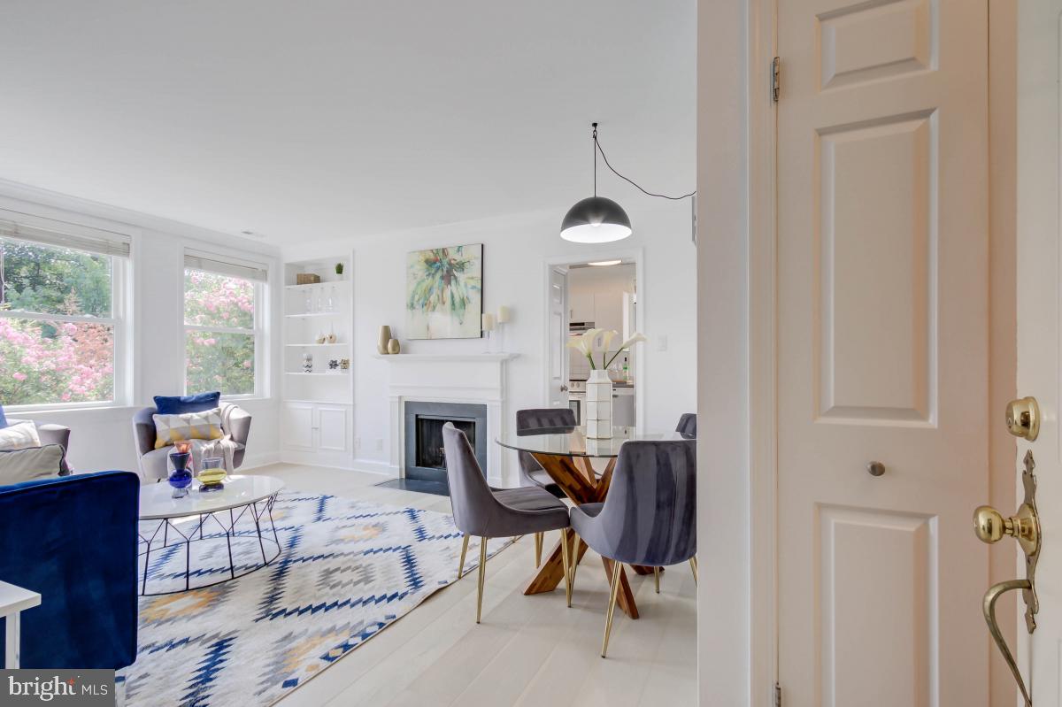 1201 O Street Northwest, Unit 2A Washington, DC 20005 - Photo 5 of 31 a living room with furniture a fireplace and a window