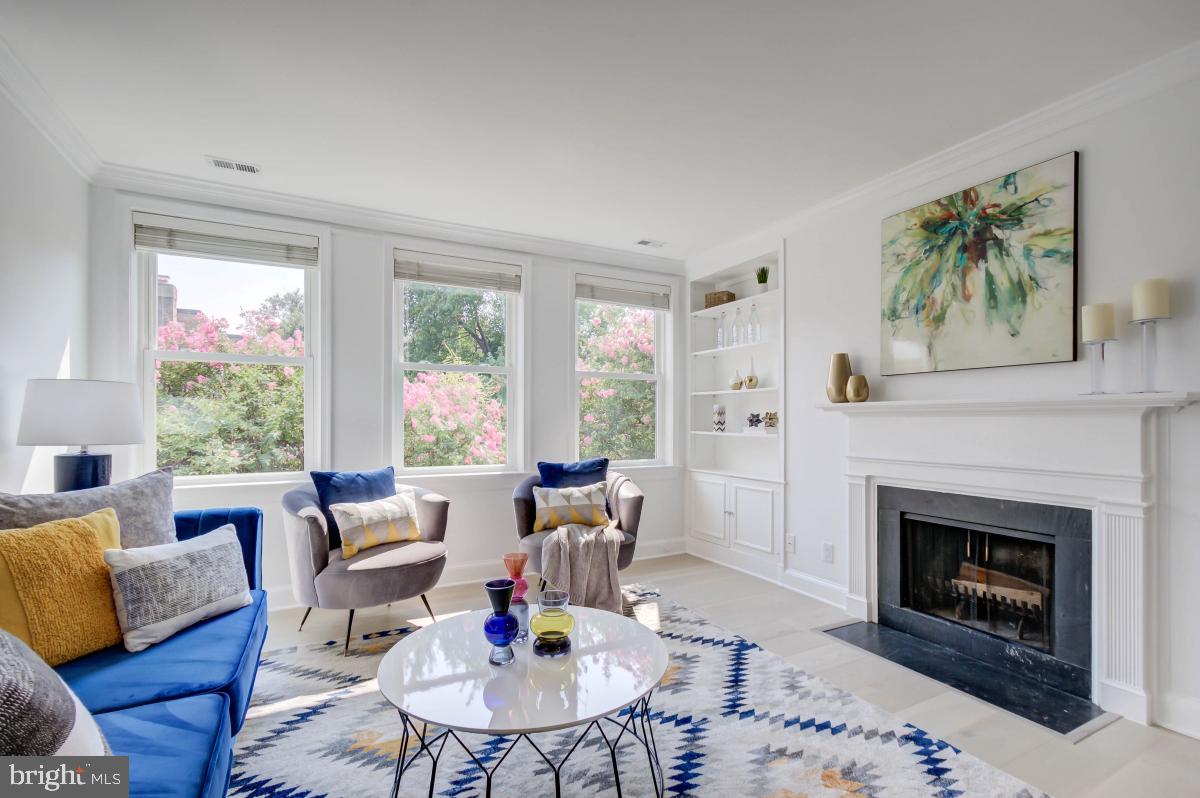 1201 O Street Northwest, Unit 2A Washington, DC 20005 - Photo 7 of 31 a living room with furniture and a fireplace