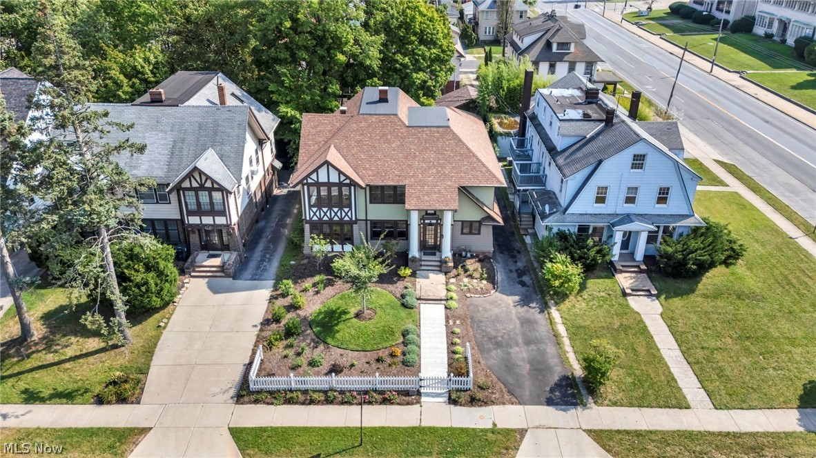 2135 Coventry Road, Unit UP Cleveland Heights, OH 44118 - Photo 37 of 38 Tudor Revival architecture featuring a prominent gable roof, decorative half-timbering, and a well-maintained front yard with mature landscaping