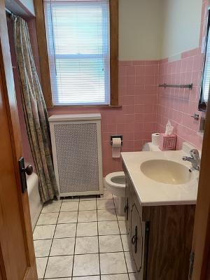 6130 West Patterson Avenue Chicago, IL 60634 - Photo 11 of 16 a bathroom with a sink a toilet and a mirror