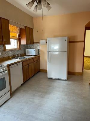 6130 West Patterson Avenue Chicago, IL 60634 - Photo 7 of 16 a kitchen with a sink stainless steel appliances and cabinets