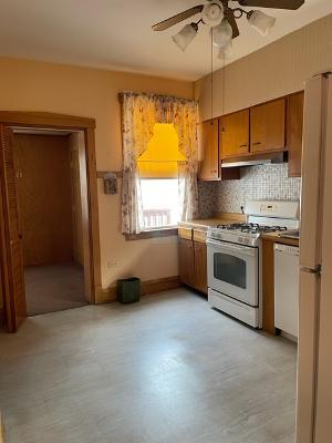 6130 West Patterson Avenue Chicago, IL 60634 - Photo 8 of 16 a kitchen with a stove a sink and a refrigerator