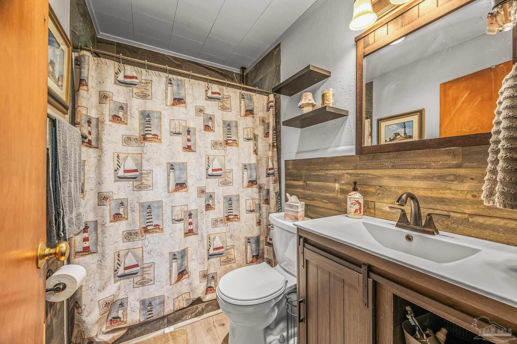 3015 Molino Road Molino, FL 32577 - Photo 14 of 35 a bathroom with a sink and a toilet