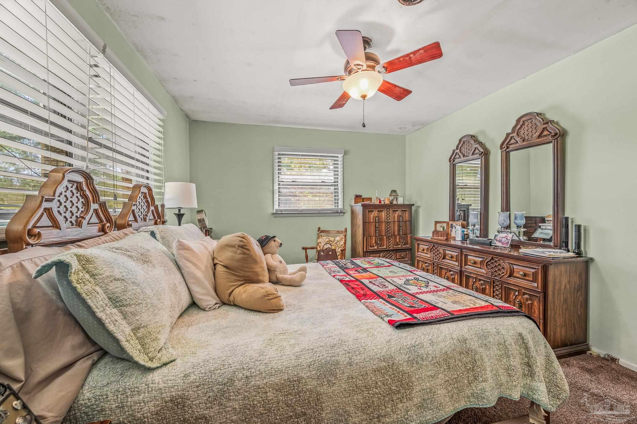 3015 Molino Road Molino, FL 32577 - Photo 16 of 35 a bedroom with a bed and a chandelier