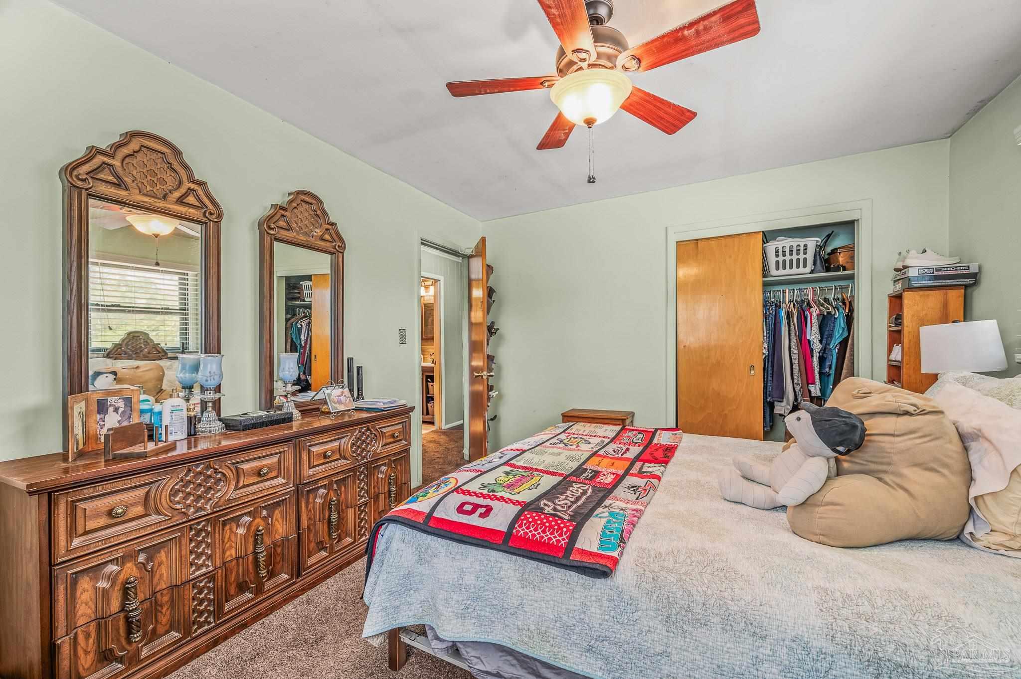 3015 Molino Road Molino, FL 32577 - Photo 17 of 35 a bedroom with double bed and a dresser