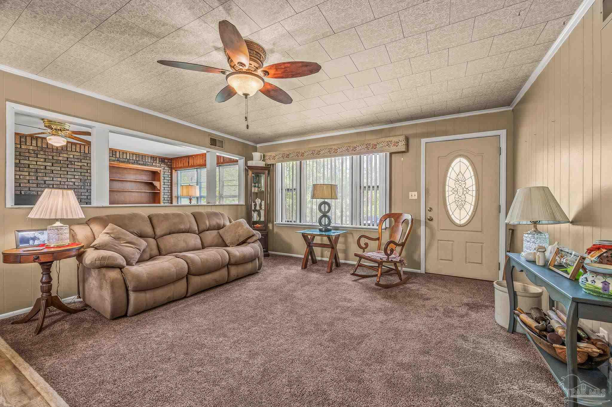 3015 Molino Road Molino, FL 32577 - Photo 21 of 35 a living room with furniture a chandelier fan and a large window