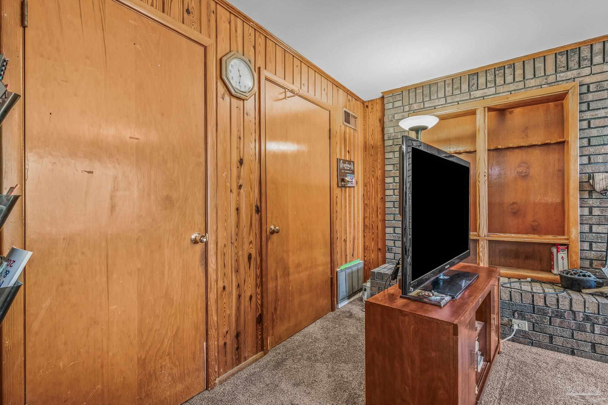 3015 Molino Road Molino, FL 32577 - Photo 23 of 35 a living room with a flat screen tv and a refrigerator