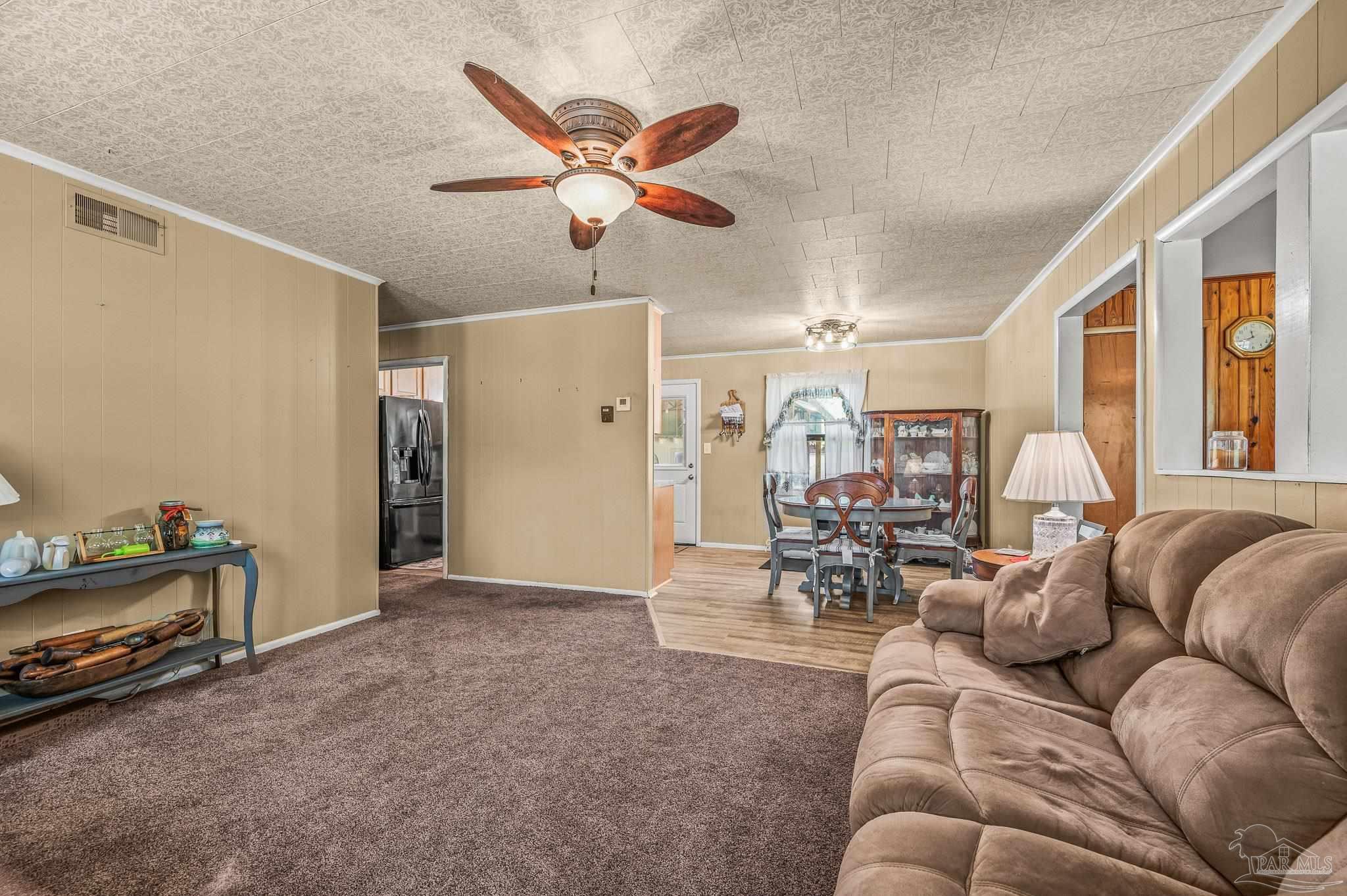 3015 Molino Road Molino, FL 32577 - Photo 26 of 35 a living room with furniture and a chandelier