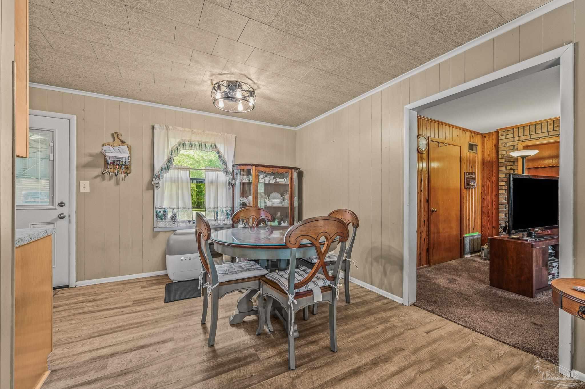 3015 Molino Road Molino, FL 32577 - Photo 28 of 35 a view of a dining room with furniture window and wooden floor