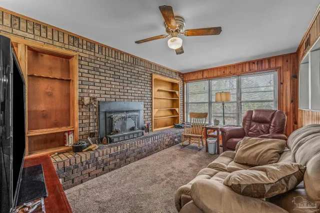 a living room with furniture a window and a fireplace