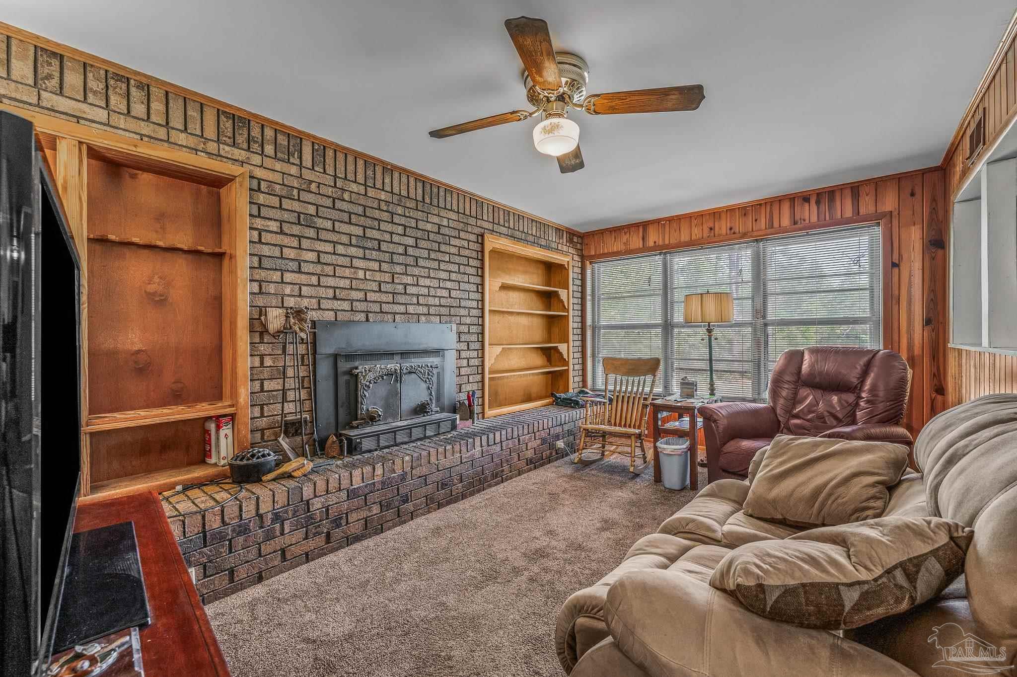 3015 Molino Road Molino, FL 32577 - Photo 29 of 35 a living room with furniture a window and a fireplace
