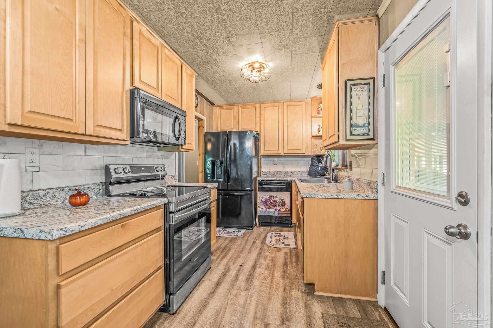 3015 Molino Road Molino, FL 32577 - Photo 32 of 35 a kitchen with a refrigerator stove and sink