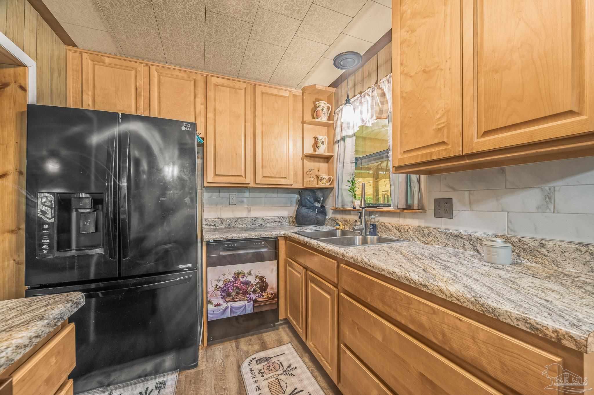 3015 Molino Road Molino, FL 32577 - Photo 33 of 35 a kitchen with a refrigerator sink and cabinets