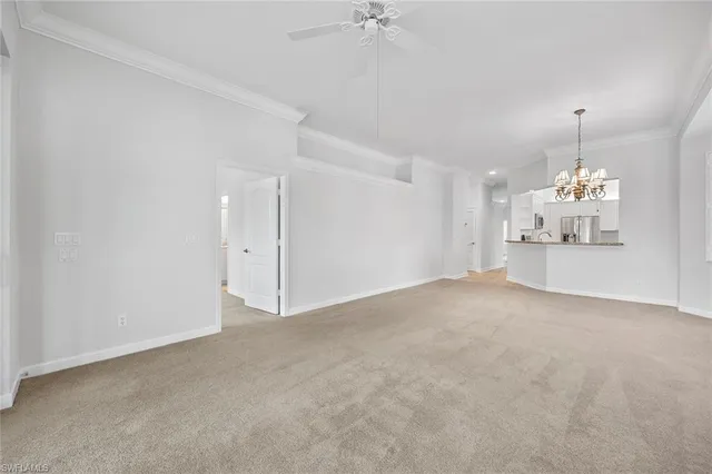 a view of a livingroom with a chandelier fan windows and chandelier fan