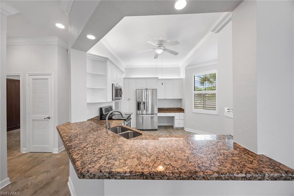 2432 Ravenna Boulevard, Unit 201 Naples, FL 34109 - Photo 14 of 50 a living room with furniture a large window