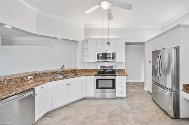 a kitchen with stainless steel appliances granite countertop a refrigerator a stove a sink and dishwasher