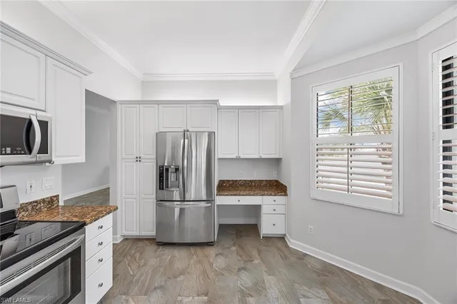 a kitchen with stainless steel appliances a refrigerator and a stove top oven