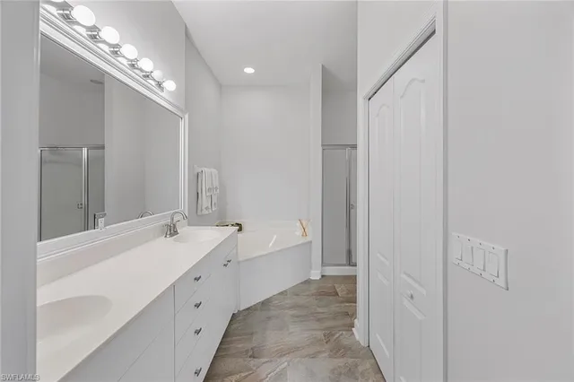 a spacious bathroom with a double vanity sink and a mirror