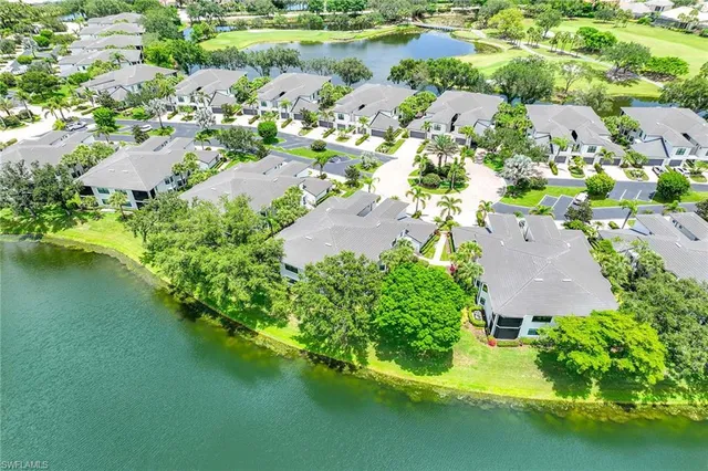 an aerial view of residential houses with outdoor space and river