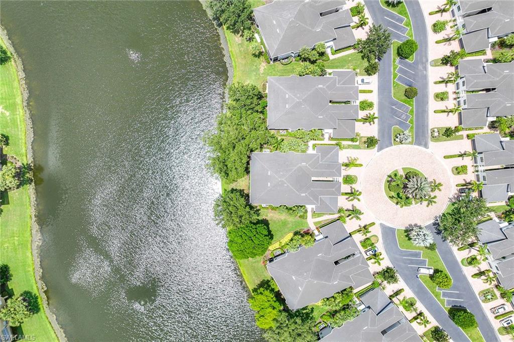 2432 Ravenna Boulevard, Unit 201 Naples, FL 34109 - Photo 38 of 49 an aerial view of a house with a yard and a large tree
