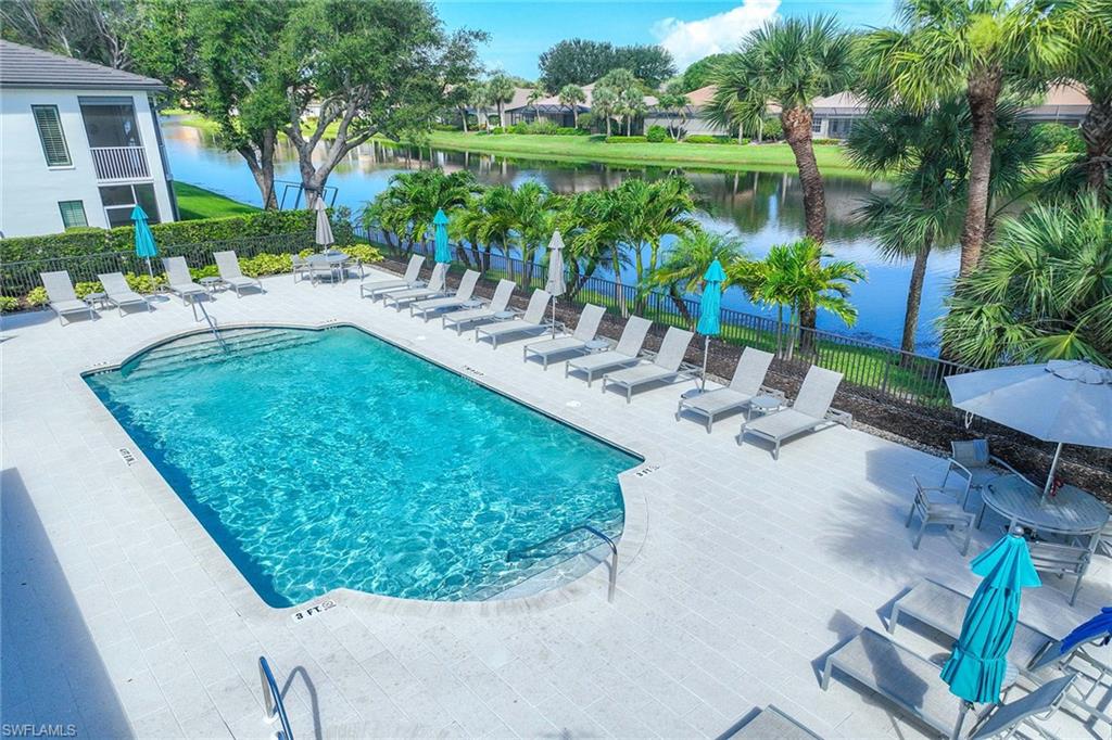 2432 Ravenna Boulevard, Unit 201 Naples, FL 34109 - Photo 40 of 49 a view of a backyard with plants and lake view