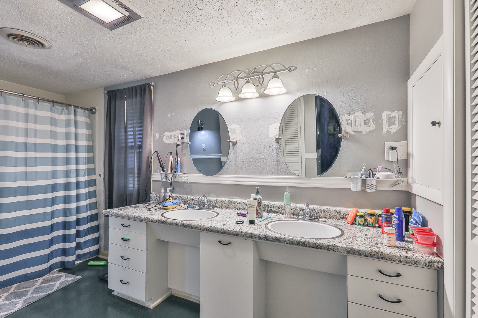 750 Risser Avenue Muskogee, OK 74403 - Photo 14 of 24 Master Bathroom. Dual vanity with integrated sinks, granite-look countertop, and white cabinetry