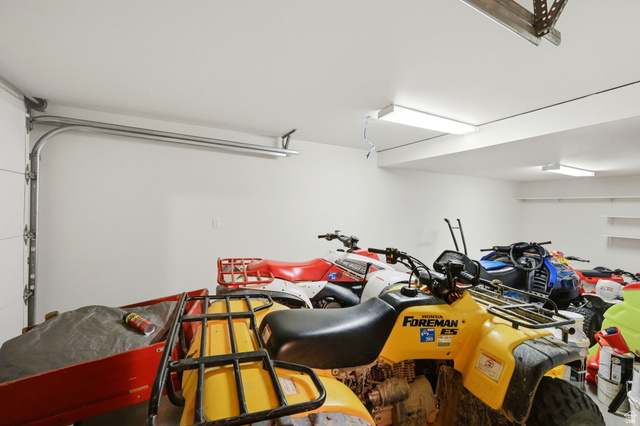 11192 Maple Road, Unit 7 Heber City, UT 84032 - Photo 35 of 51 Garage with white walls, overhead lighting, and integrated shelving
