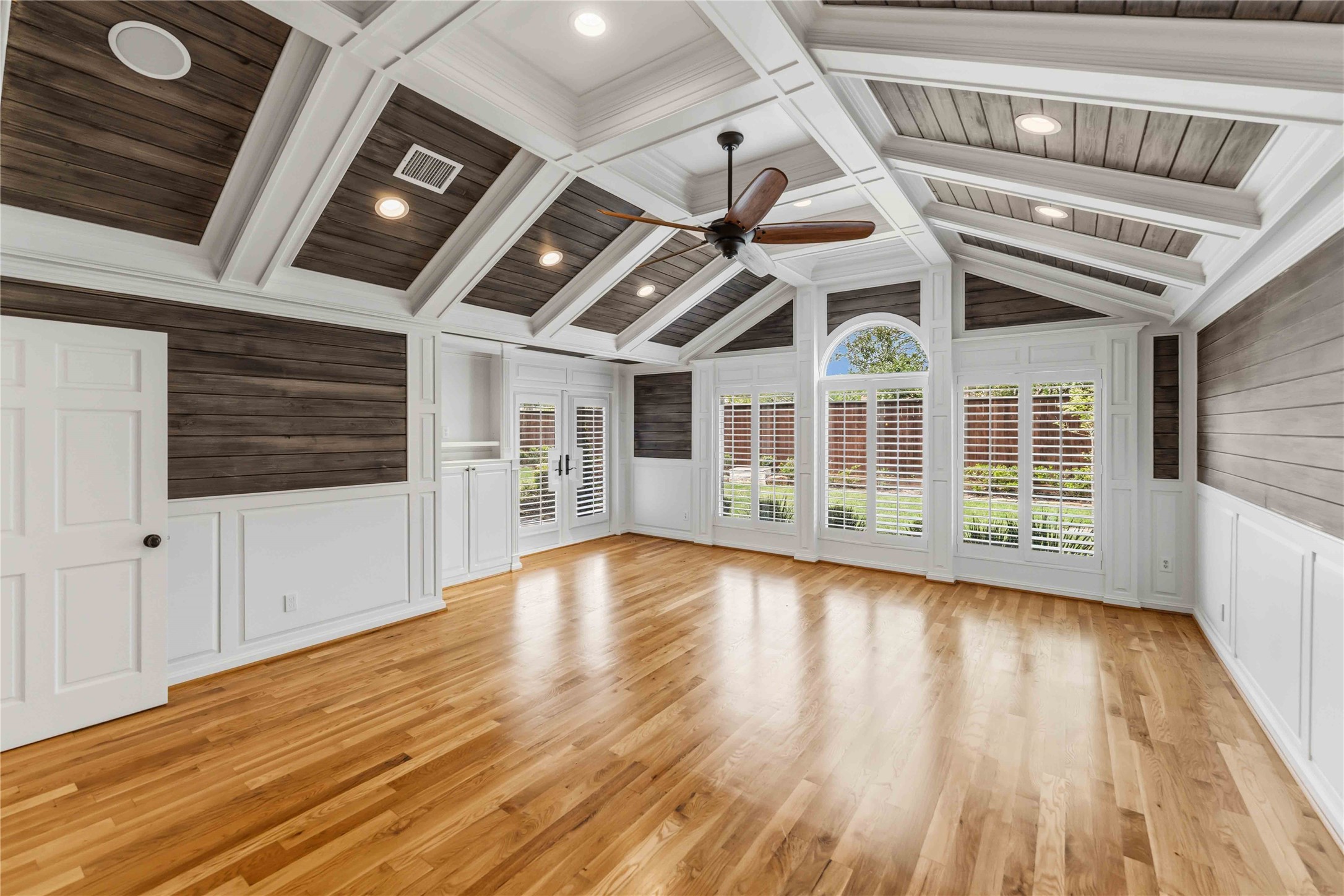 4031 Fernwood Drive Houston, TX 77021 - Photo 14 of 34 a view of an empty room with wooden floor and a ceiling fan