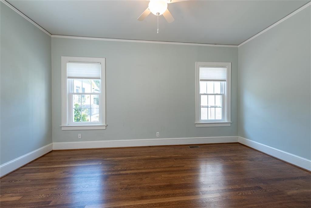208 Shadowmoor Drive, Unit 208 Decatur, GA 30030 - Photo 12 of 29 an empty room with wooden floor and windows