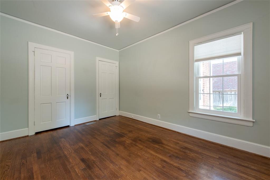 208 Shadowmoor Drive, Unit 208 Decatur, GA 30030 - Photo 15 of 29 an empty room with wooden floor and windows