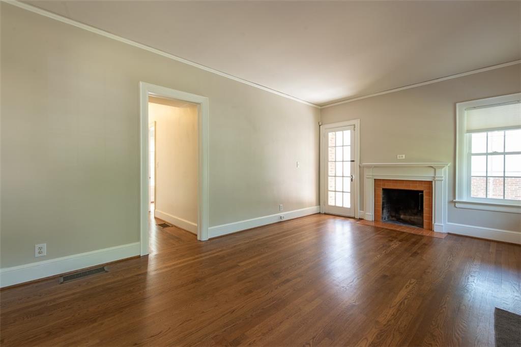 208 Shadowmoor Drive, Unit 208 Decatur, GA 30030 - Photo 2 of 29 an empty room with wooden floor fireplace and windows