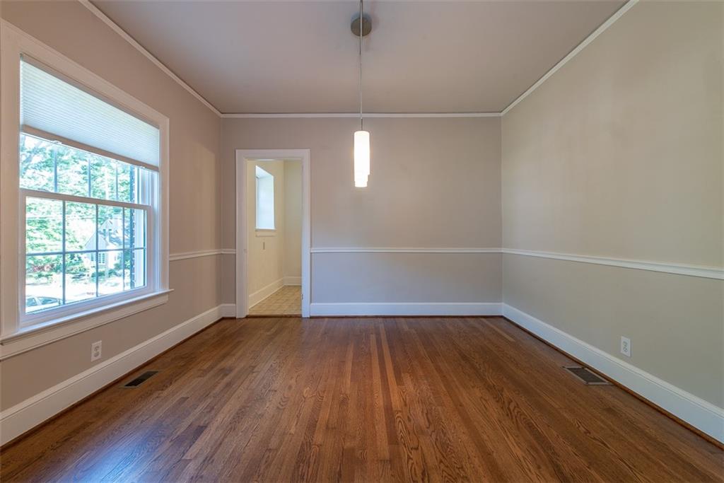 208 Shadowmoor Drive, Unit 208 Decatur, GA 30030 - Photo 23 of 29 an empty room with wooden floor and windows