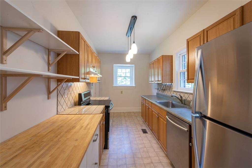 208 Shadowmoor Drive, Unit 208 Decatur, GA 30030 - Photo 25 of 29 a kitchen with stainless steel appliances granite countertop a refrigerator a stove and a sink