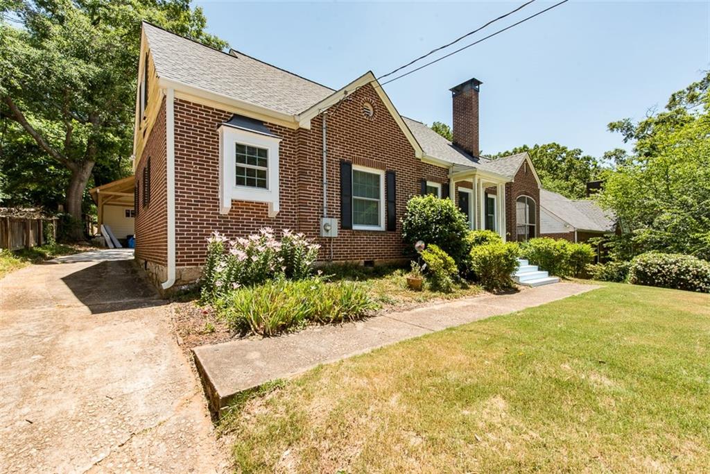 208 Shadowmoor Drive, Unit 208 Decatur, GA 30030 - Photo 29 of 29 a front view of a house with a yard and garage