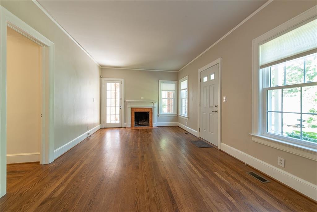 208 Shadowmoor Drive, Unit 208 Decatur, GA 30030 - Photo 3 of 29 a view of empty room with wooden floor and fireplace