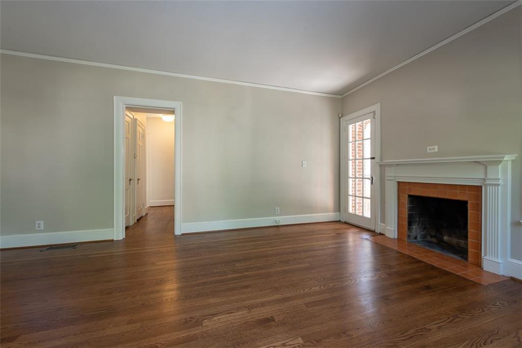 208 Shadowmoor Drive, Unit 208 Decatur, GA 30030 - Photo 4 of 29 an empty room with wooden floor fireplace and windows