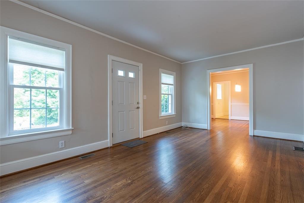 208 Shadowmoor Drive, Unit 208 Decatur, GA 30030 - Photo 5 of 29 a view of an empty room with wooden floor and a window